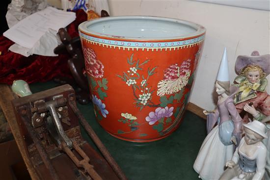 A Chinese coral ground famille rose jardiniere, wood stand Total height 60cm
